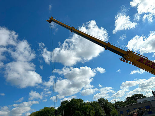 Large crane used to lift and install signage