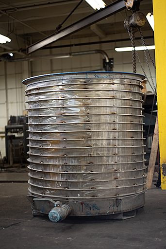 Large water-cooled tank used in paint industry that has steel tubing wrapped around its exterior