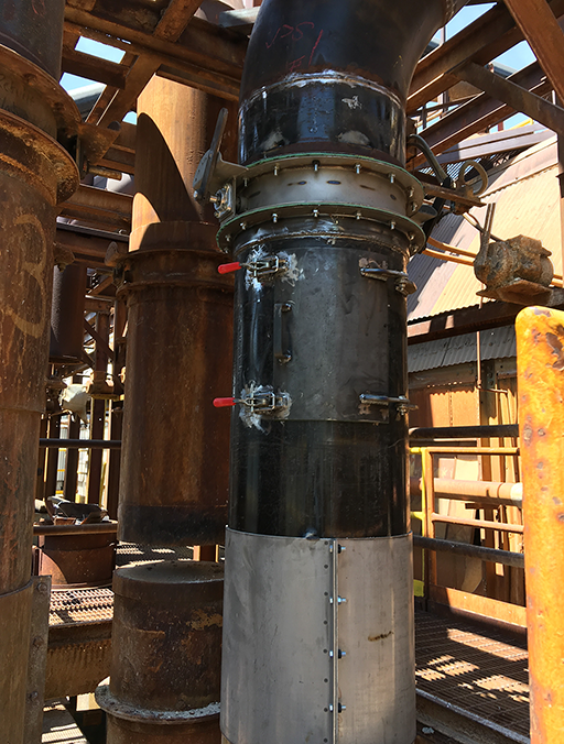 vertical scrubber pipe with an access panel and latches below a custom valve a the top before the bend in the pipe