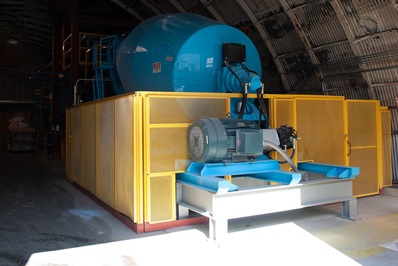 Machine guard / cage (painted yellow) around a large equipment area