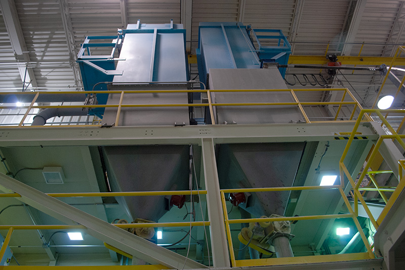 a row of three structural frameworks supporting industrial systems