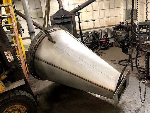 Welding of transitional fitting in-progress showing pieces clamped together