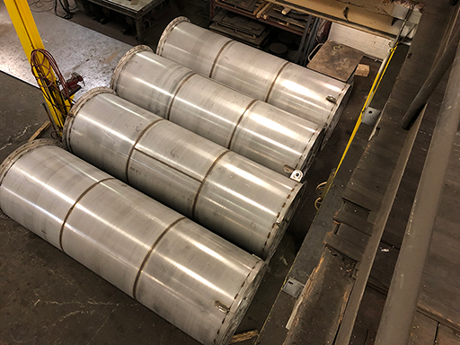 aerial view of 4 large scrubber pipe sections laying next to one another