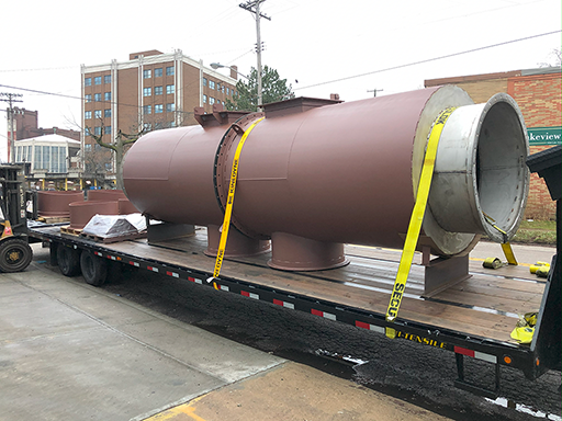 Street view of 2 scrubber sections loaded on a semi truck
