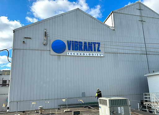 final signage (blue) completed on the exterior of a white building