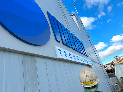 Close-up view of signage install on second story of building exterior