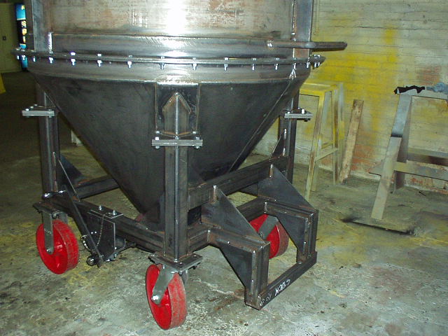 Side view of a hopper with red wheels