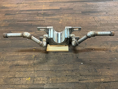 close-up of smelter feed spout showing detailed welds