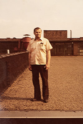 Thomas J. Rusnak standing on roof of building (early 1980s)